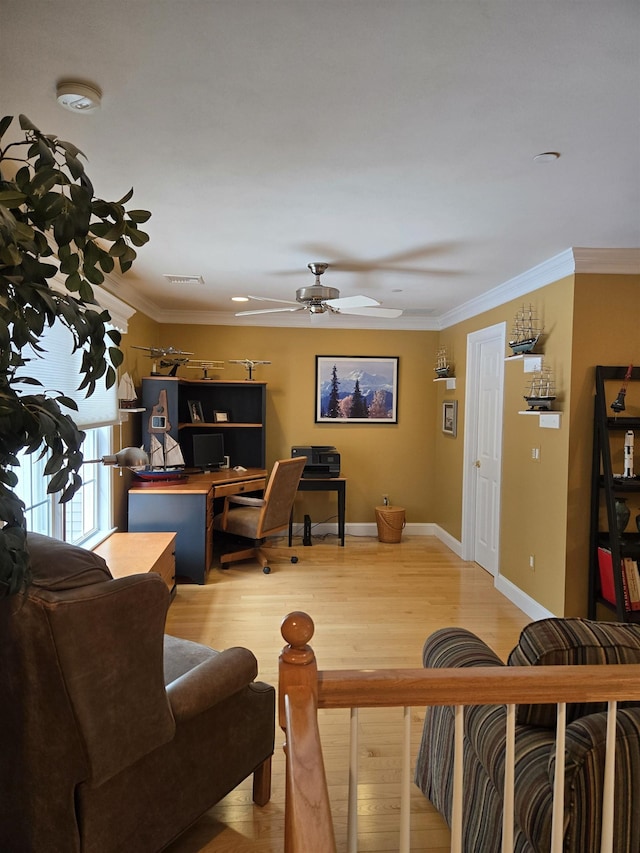 living room with visible vents, crown molding, baseboards, and wood finished floors