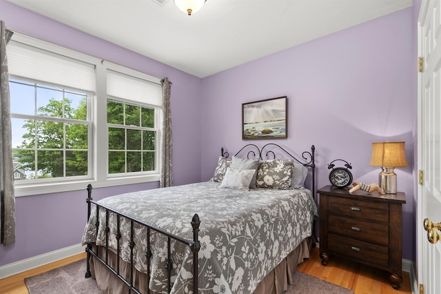 bedroom featuring wood finished floors and baseboards