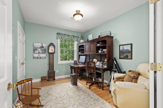 office space featuring light wood-type flooring and baseboards