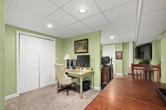 carpeted home office with baseboards, a drop ceiling, and recessed lighting