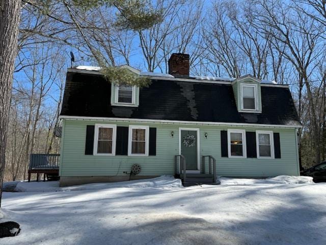 dutch colonial with a chimney and a gambrel roof