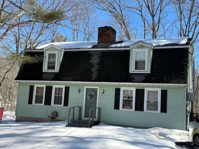 dutch colonial featuring a chimney and a gambrel roof