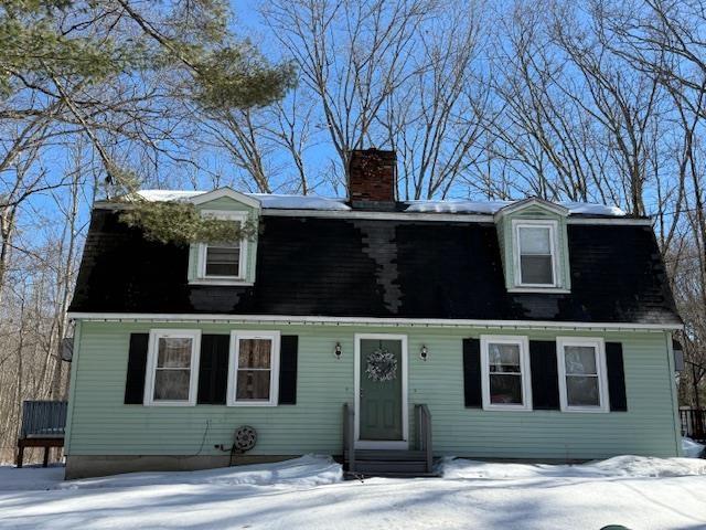 dutch colonial with entry steps, a chimney, and a gambrel roof