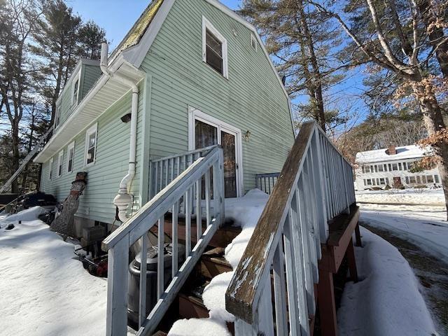 exterior space with stairway and a gambrel roof