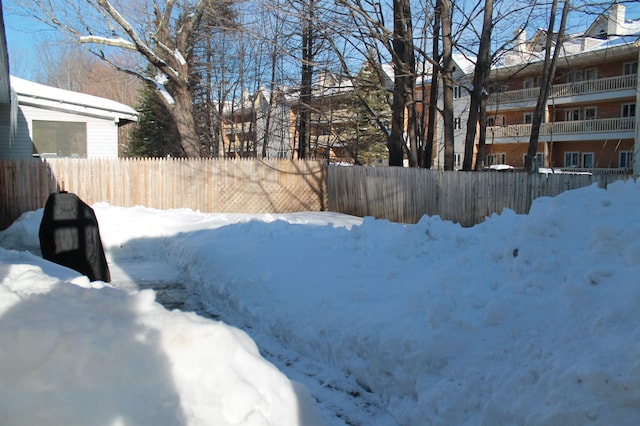 snowy yard with fence