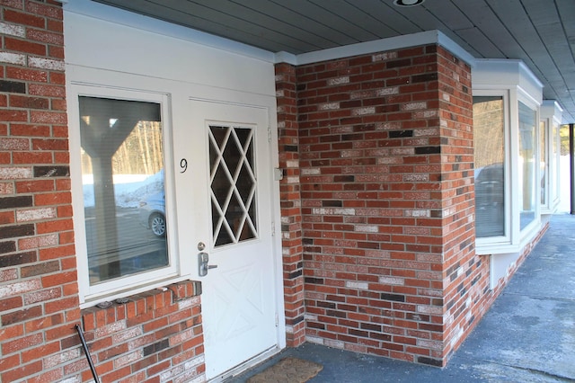 entrance to property with brick siding