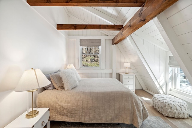 bedroom with vaulted ceiling with beams, wooden ceiling, and wood finished floors