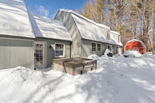 view of snow covered rear of property