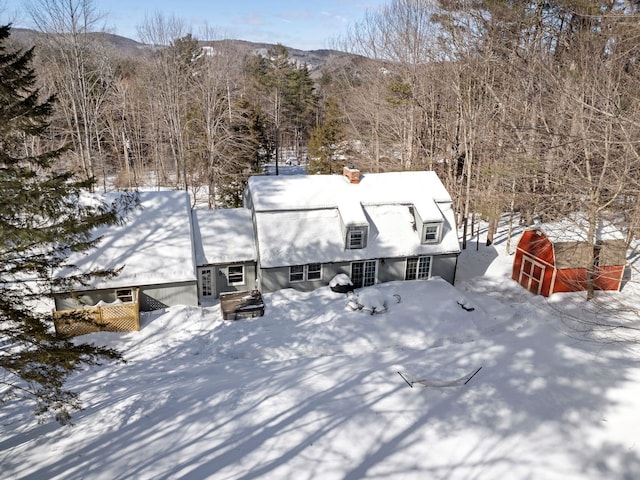 snowy aerial view featuring a mountain view