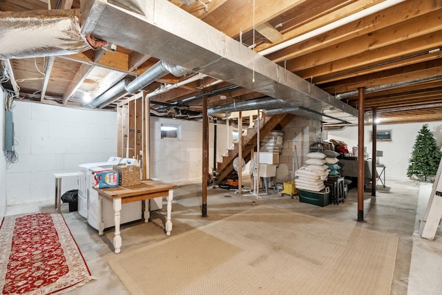 unfinished basement with washer and clothes dryer and stairs