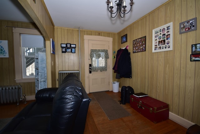 doorway featuring radiator heating unit and wooden walls