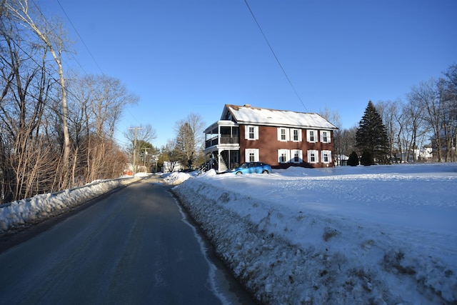 snow covered property featuring a balcony