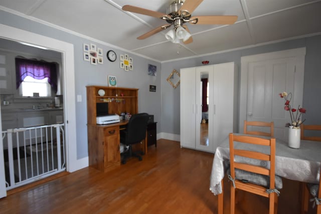 office area with a ceiling fan, crown molding, baseboards, and wood finished floors