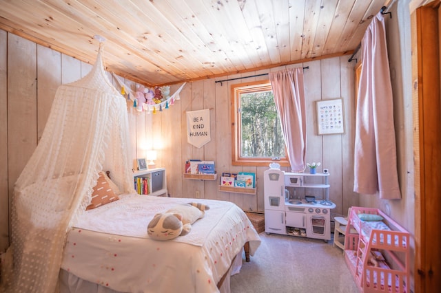 carpeted bedroom with wood ceiling and wooden walls