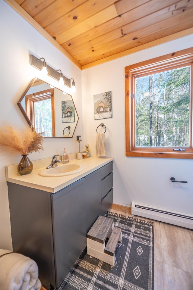 bathroom with a baseboard heating unit, wood ceiling, and vanity