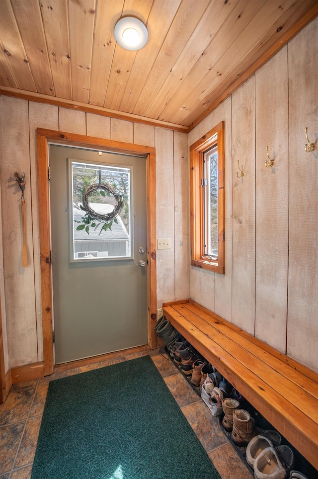 mudroom with wood ceiling and wooden walls