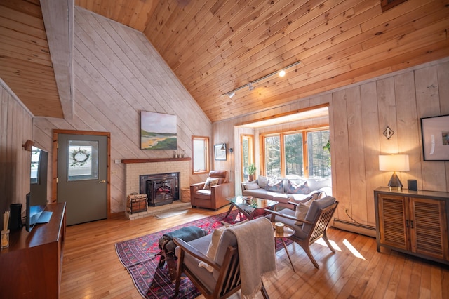 living area with wood ceiling, wood-type flooring, rail lighting, wood walls, and high vaulted ceiling