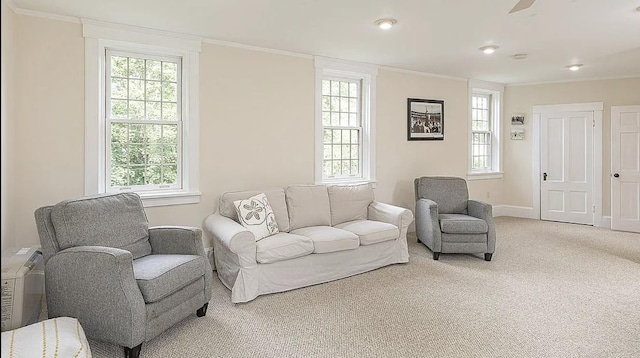 living room featuring ornamental molding, carpet flooring, and baseboards