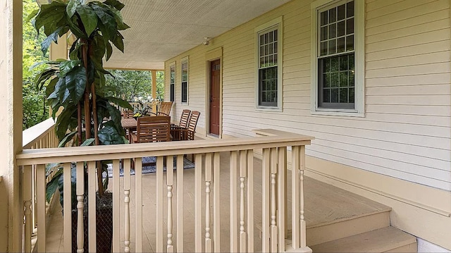 wooden terrace featuring covered porch