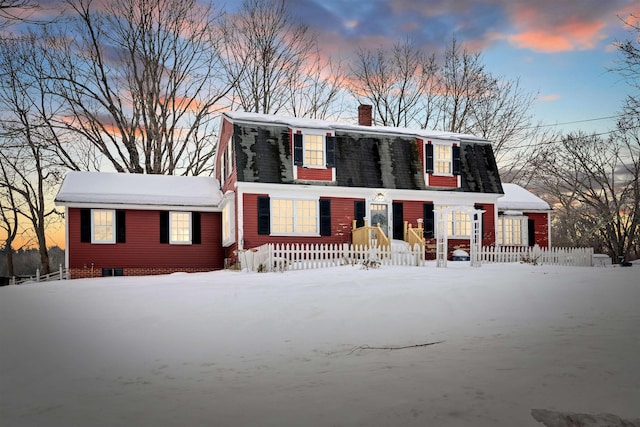 dutch colonial with a chimney and a gambrel roof