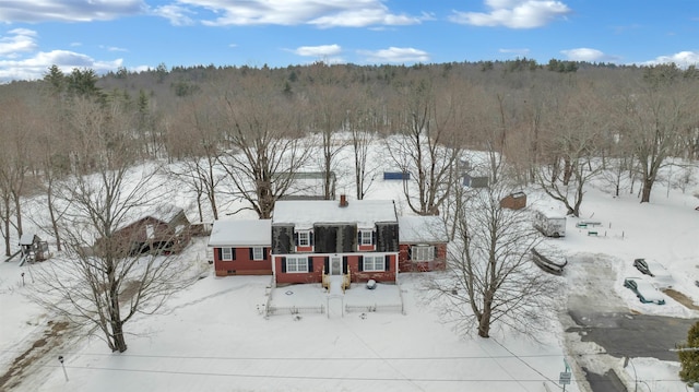 snowy aerial view with a forest view