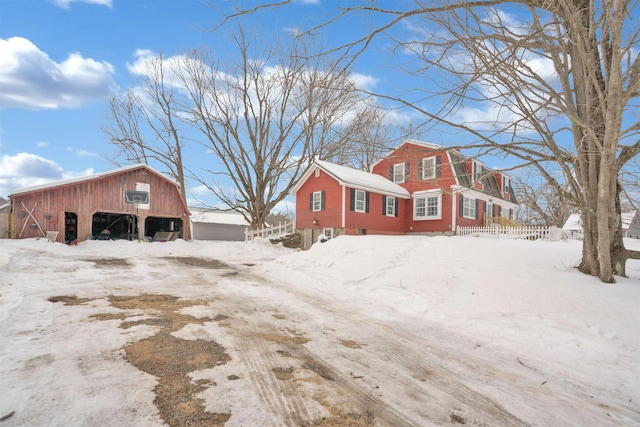 view of snow covered exterior featuring an outbuilding