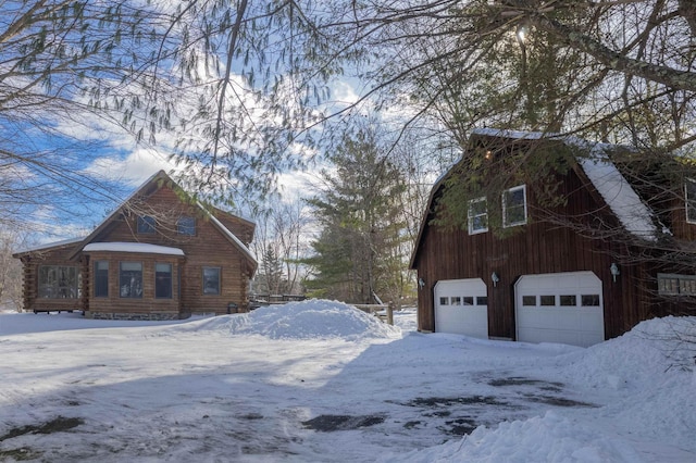 yard covered in snow with a detached garage