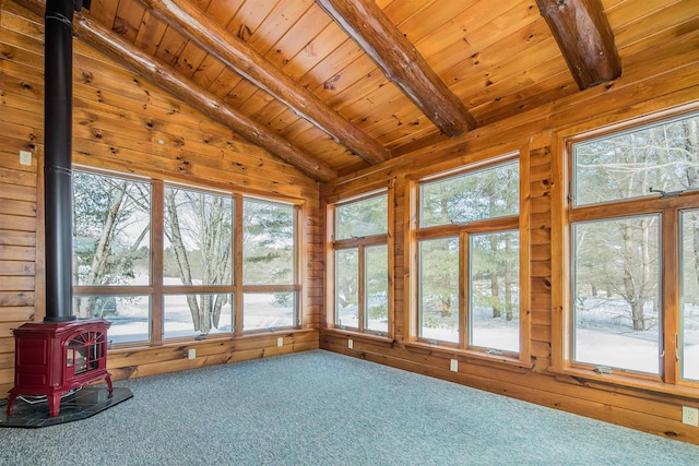 unfurnished sunroom with a wood stove, wood ceiling, and lofted ceiling with beams