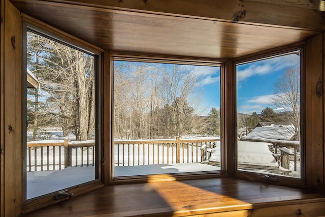 unfurnished sunroom featuring wood ceiling and a wealth of natural light