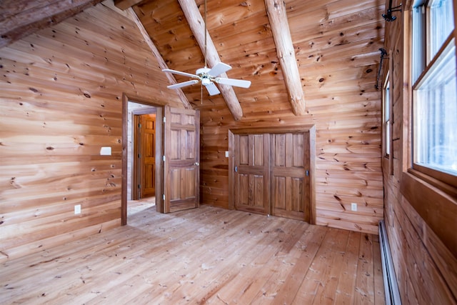 bonus room with beam ceiling, a baseboard radiator, light wood-style floors, wood ceiling, and wood walls