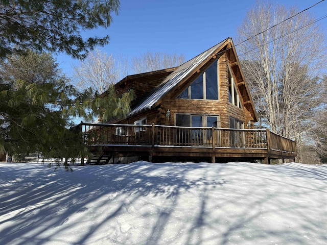 snow covered property featuring a wooden deck