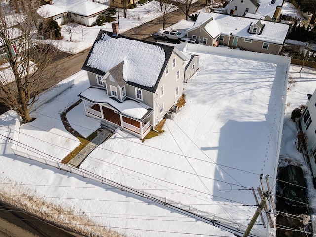 snowy aerial view with a residential view