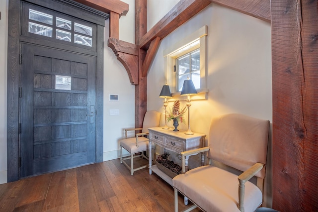 foyer with baseboards and hardwood / wood-style floors