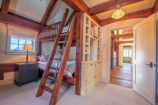 bedroom with light carpet and lofted ceiling with beams