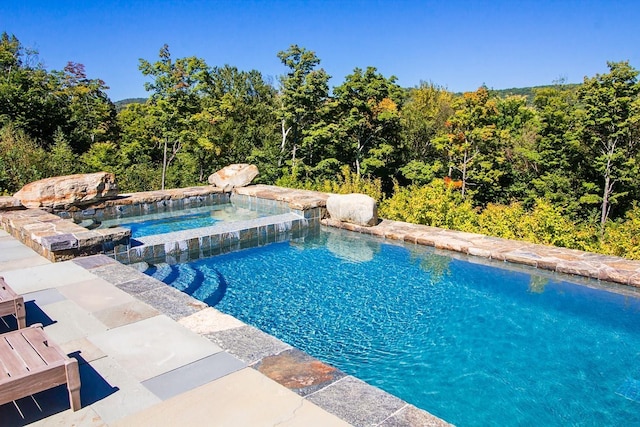 view of pool featuring a pool with connected hot tub