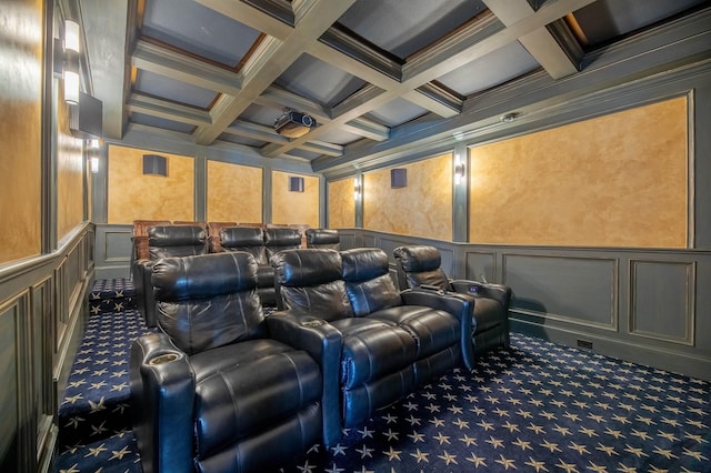 home theater featuring carpet, a decorative wall, and beamed ceiling