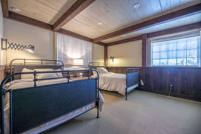 carpeted bedroom featuring a wainscoted wall, wood walls, beamed ceiling, and wood ceiling