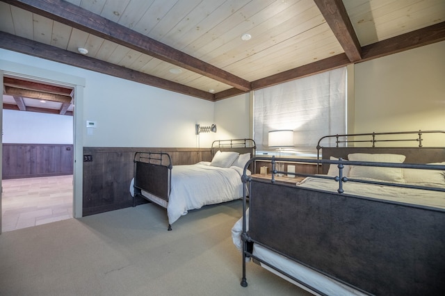 bedroom with carpet, wooden ceiling, a wainscoted wall, and wood walls