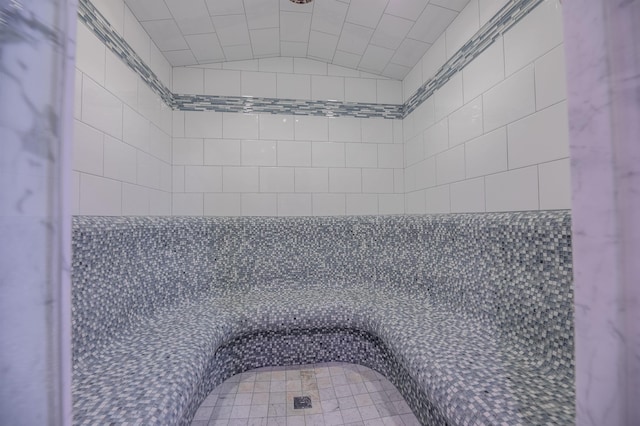 bathroom featuring lofted ceiling