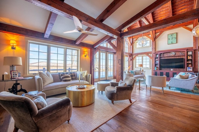 living room with ceiling fan, french doors, beamed ceiling, and wood-type flooring