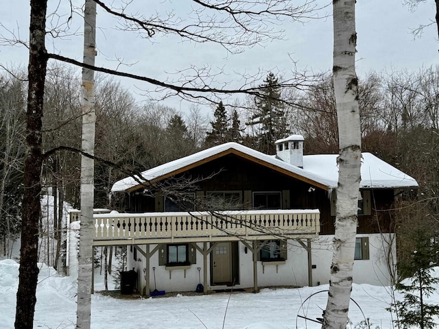 view of snow covered back of property