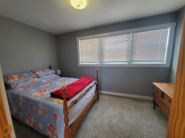 bedroom featuring baseboards and light colored carpet