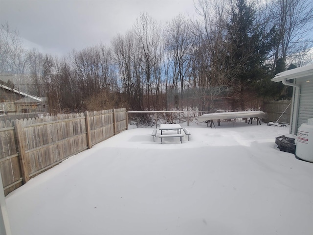 yard covered in snow with fence