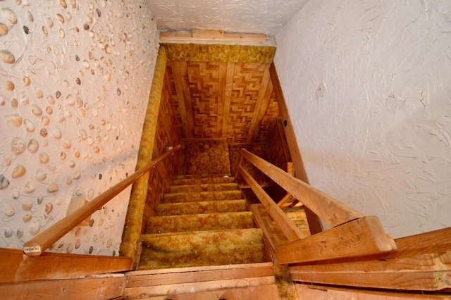 stairway with a textured wall