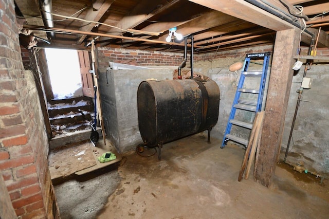 basement with heating fuel and brick wall