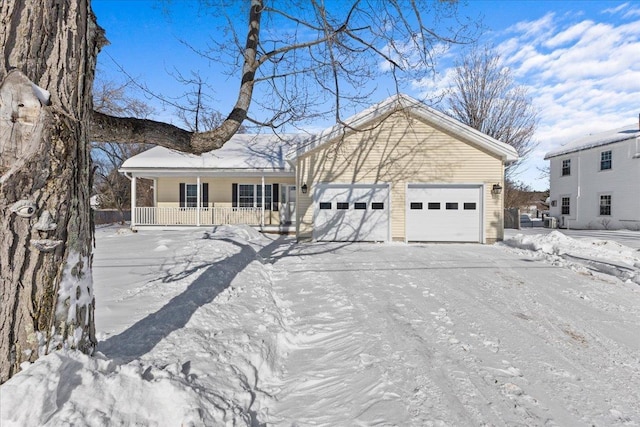 view of front of property featuring a garage, covered porch, and driveway