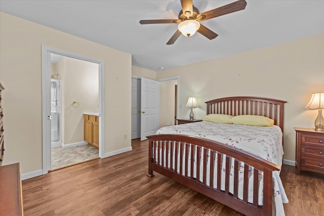 bedroom with a ceiling fan, wood finished floors, connected bathroom, and baseboards