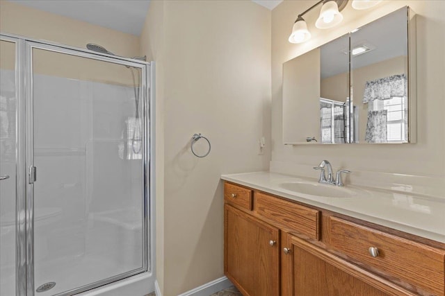 bathroom with a stall shower, visible vents, and vanity