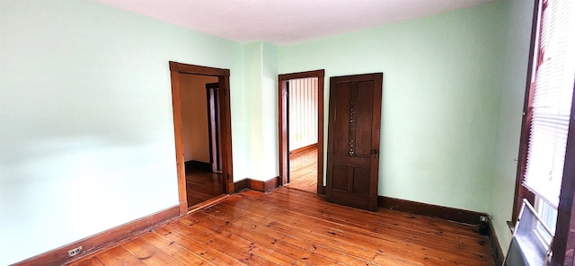 interior space featuring light wood-style flooring and baseboards