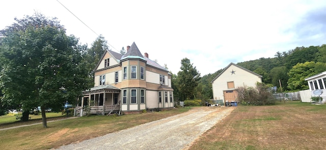 victorian home with a porch and a front yard